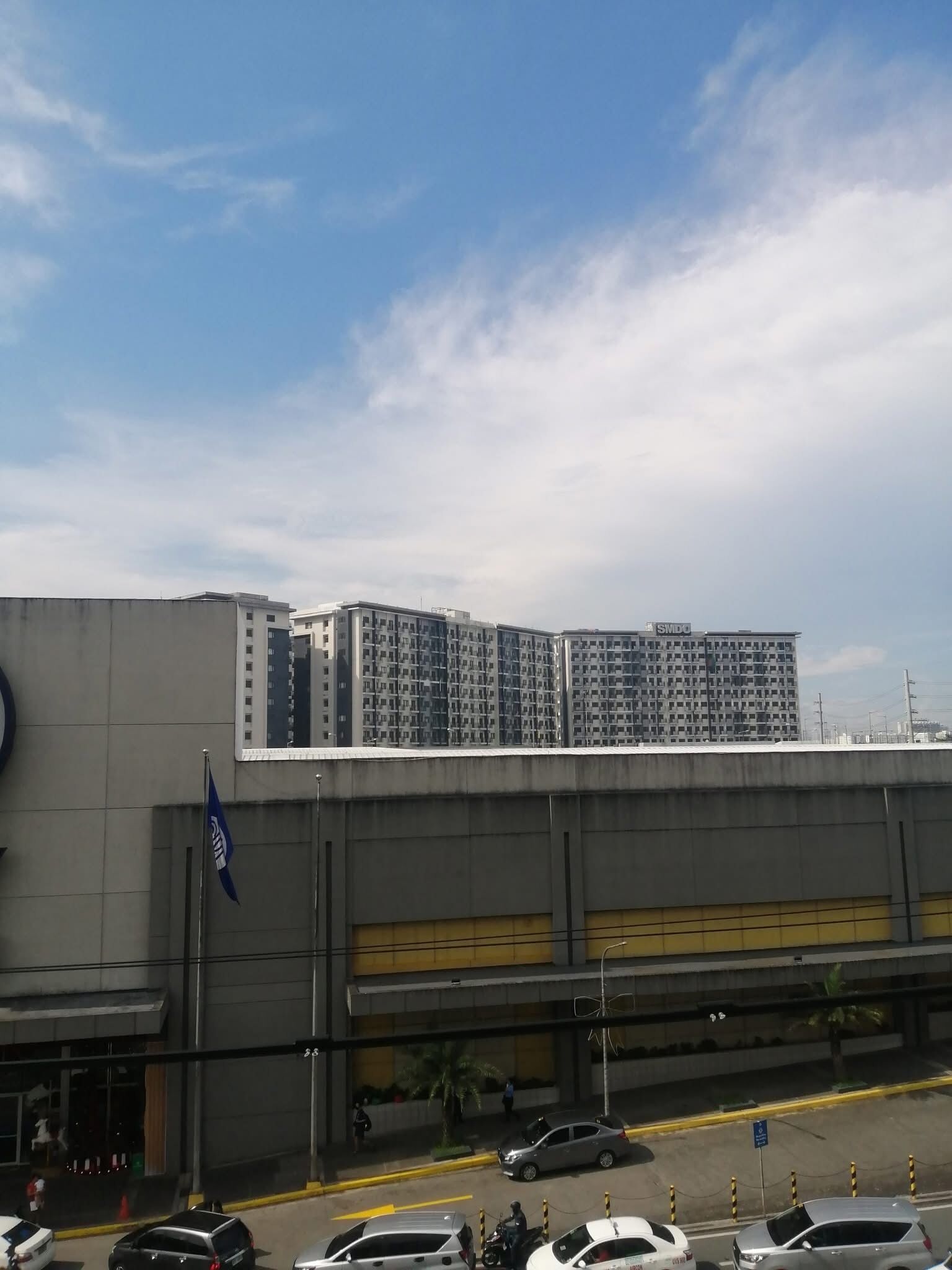 A multi-story building with a modern architectural design, featuring a mix of rectangular and square windows.