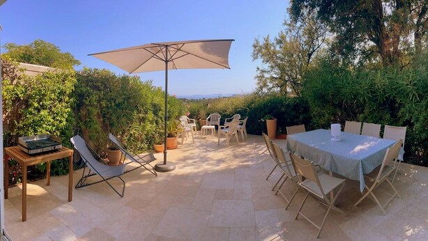 An outdoor patio with a table and chairs, surrounded by potted plants and trees. - Provencal house with sea view La Croix Valmer "Lou Mamet", ideal for families (La Croix-Valmer)