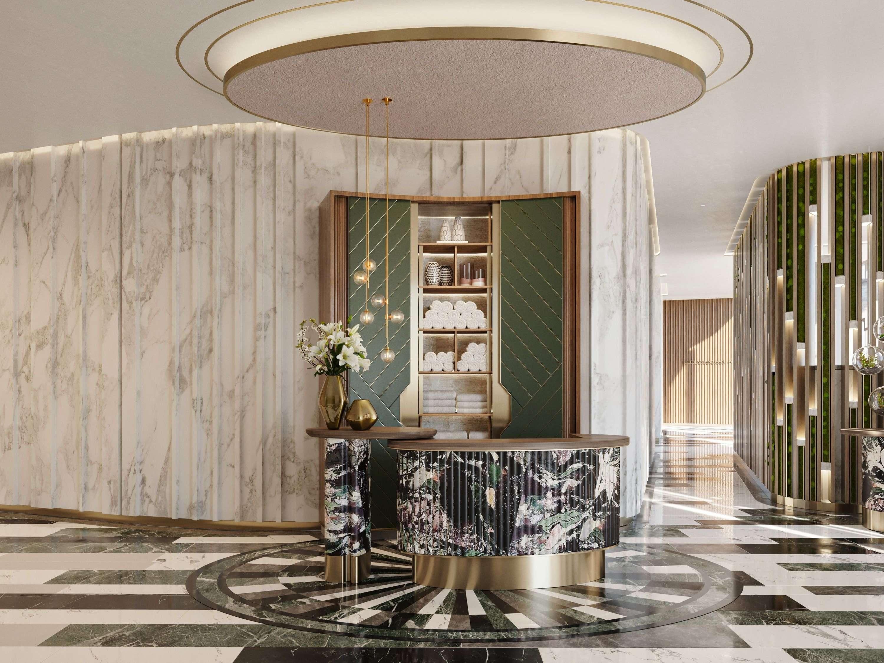 Um hall de entrada com balcão de recepção em mármore, parede decorativa verde e piso estampado.