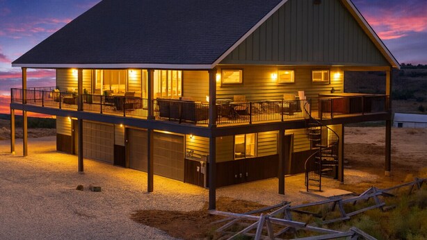 A two-story house with a covered deck and a spiral staircase. - Lakeview Lodge - Lakeside Escape (Scofield)