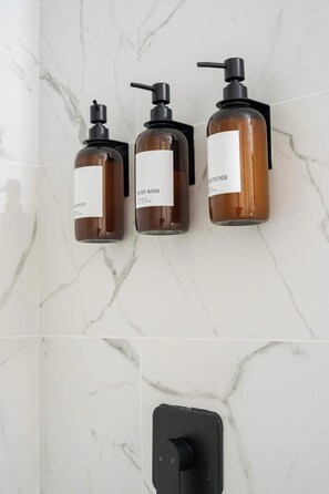 Shower, hair dryer, towels, shampoo