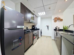 Coffee/tea maker, fridge, microwave, oven