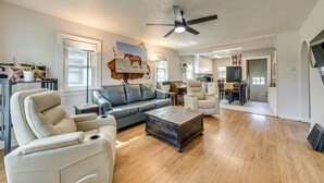 A spacious living room with a leather sofa, a coffee table, and a ceiling fan. - 2 Mi to Dtwn: Family Home in Cheyenne! (Cheyenne)
