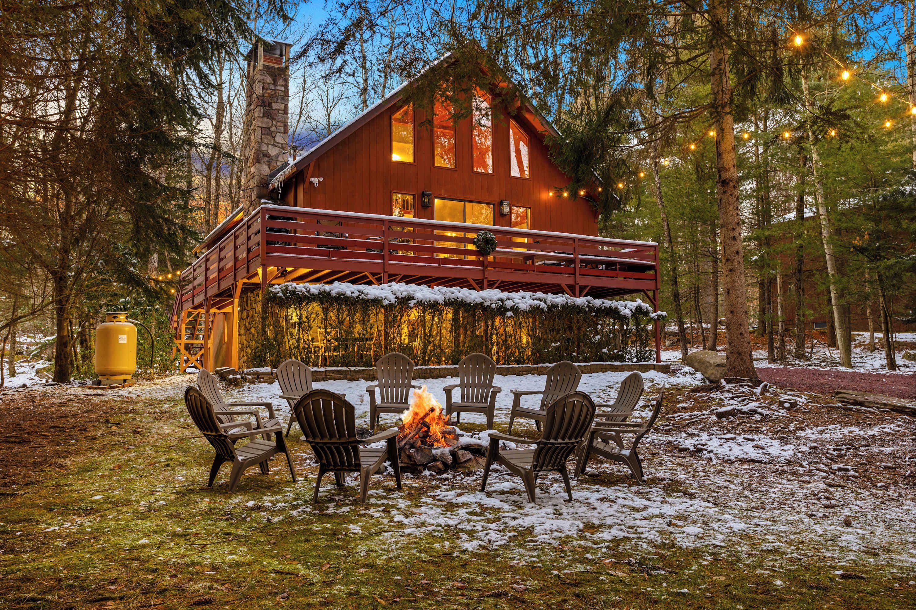 A cabin with a fire pit and outdoor seating.