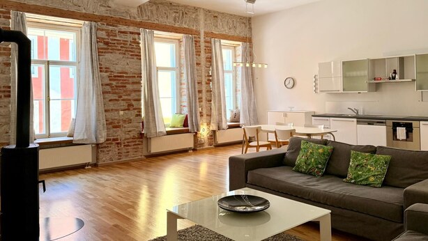 Un salon moderne avec un canapé, une table basse et un coin repas.