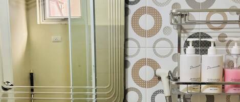 A bathroom with a sink, mirror, and toiletries shelf.