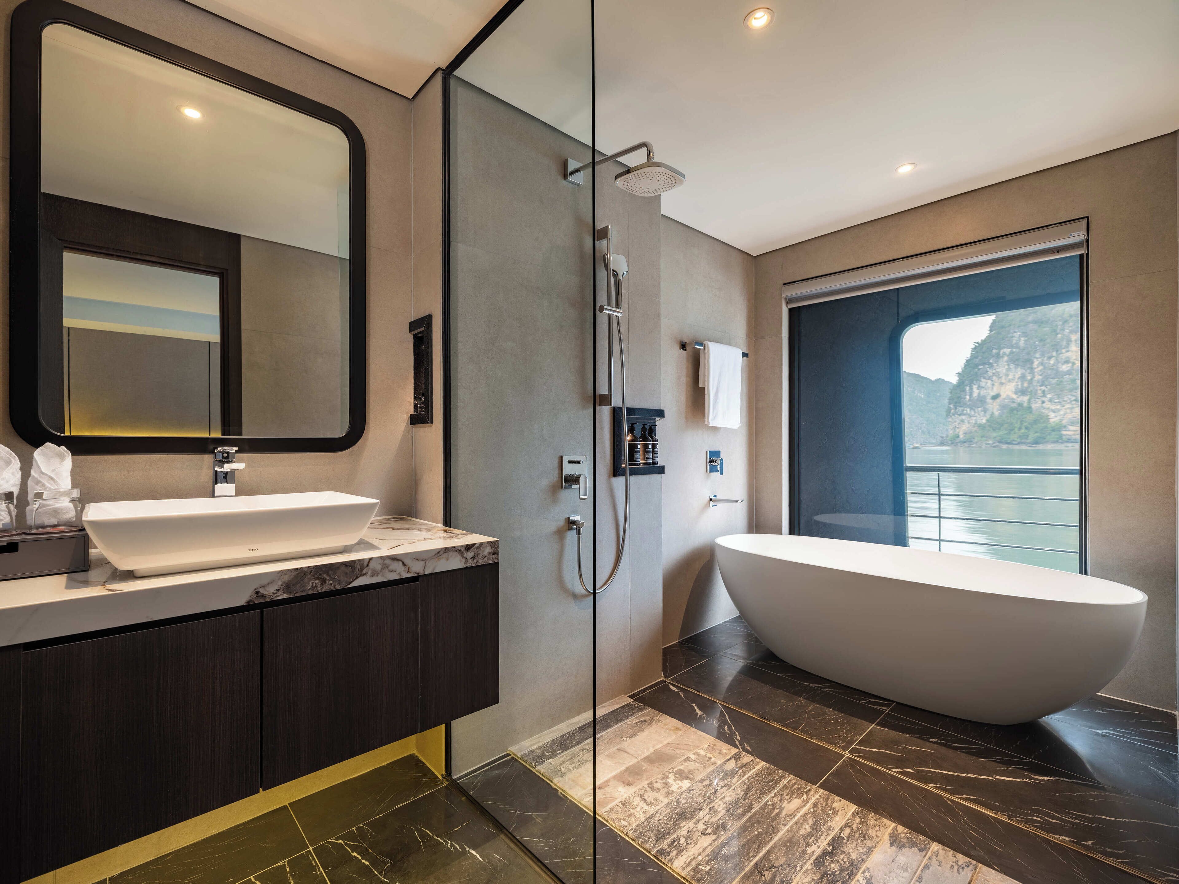 A modern bathroom with a large mirror, a freestanding bathtub, and a shower.