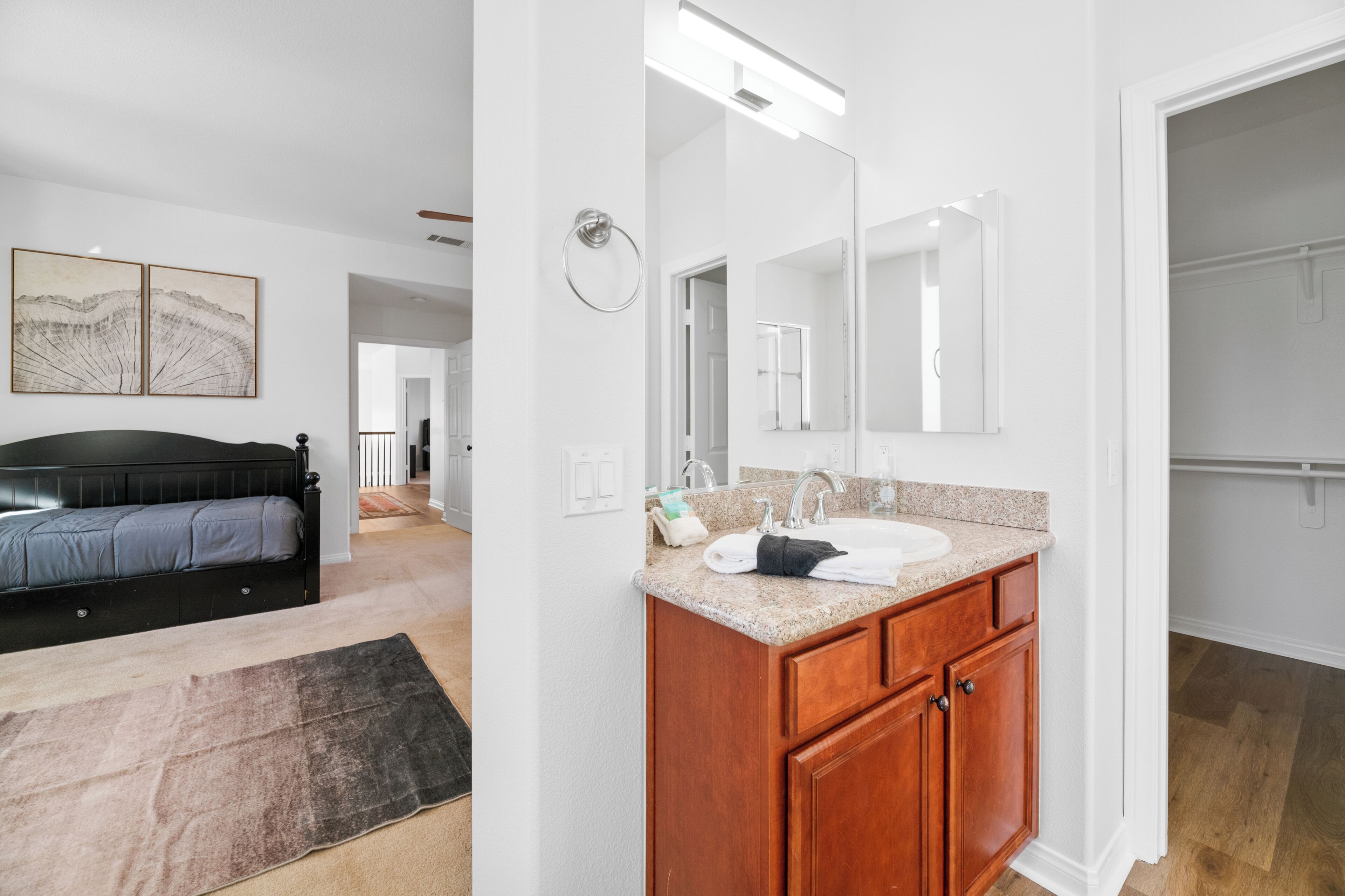 A modern bathroom with a vanity, sink, and mirror.