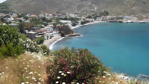 A coastal town with buildings along the shore, a mountain in the background, and a clear sky. - Apartment 'Studio 1' with Mountain View, Wi-Fi and Air Conditioning (Kalymnos)