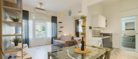 A modern apartment with a dining area, living room, and kitchen.