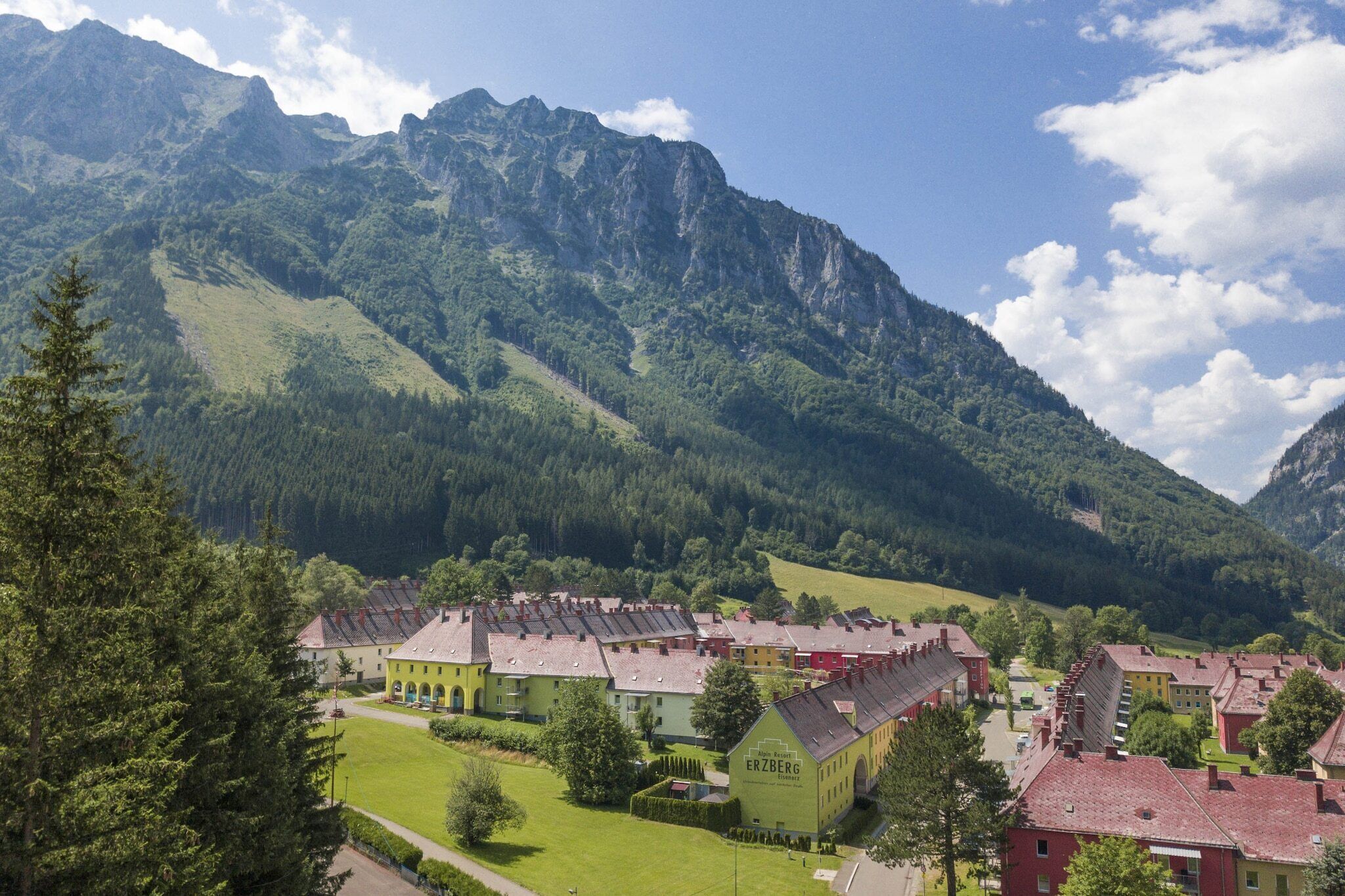 A town with traditional buildings and a mountain backdrop.
