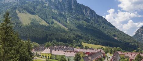 A town with traditional buildings and a mountain backdrop.