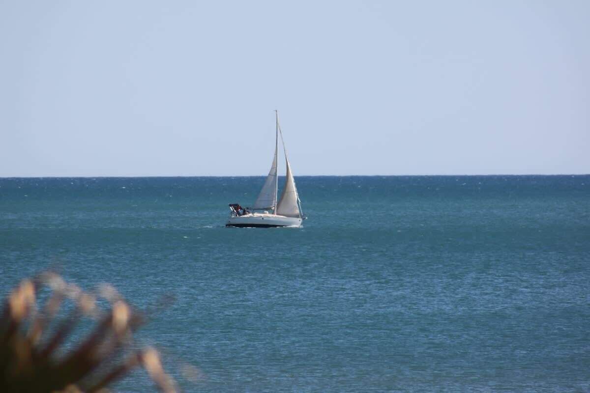 A sailboat on calm water.