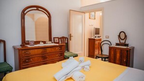A hotel room with a bed, a wooden dresser, a mirror, and a television. - rita's house (Atrani)