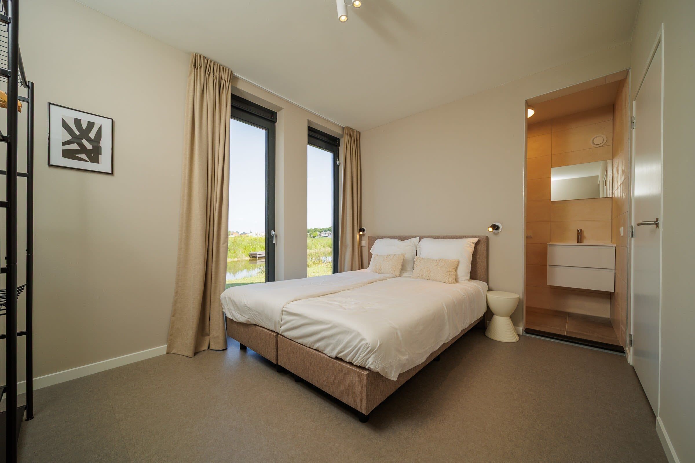 A bedroom with a bed, a window, a toilet, and a bathroom.