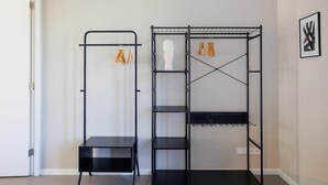 Une pièce comprenant une armoire en métal noir, une étagère en métal noir et une petite table noire.