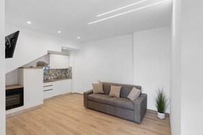 A modern kitchen with white cabinets, a built-in oven, and a backsplash with a geometric pattern. - Suite La Primula with Mountain View, Wi-Fi and Air Conditioning (Agerola)