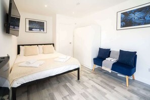 Escritorio, tabla de planchar con plancha, wifi y ropa de cama 