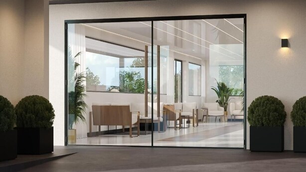 A modern lobby with a glass partition, seating area, and potted plants. - Luxe Pool-View Room Perfect for Memorable Orlando Stays (Kissimmee)