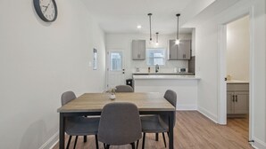 A modern kitchen with a dining area.