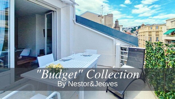 A modern outdoor dining area with a table and chairs, a glass door leading to an interior space, and a view of the cityscape in the background. - N&J - CASA SOLANA - Terrace - Centre (Niza)