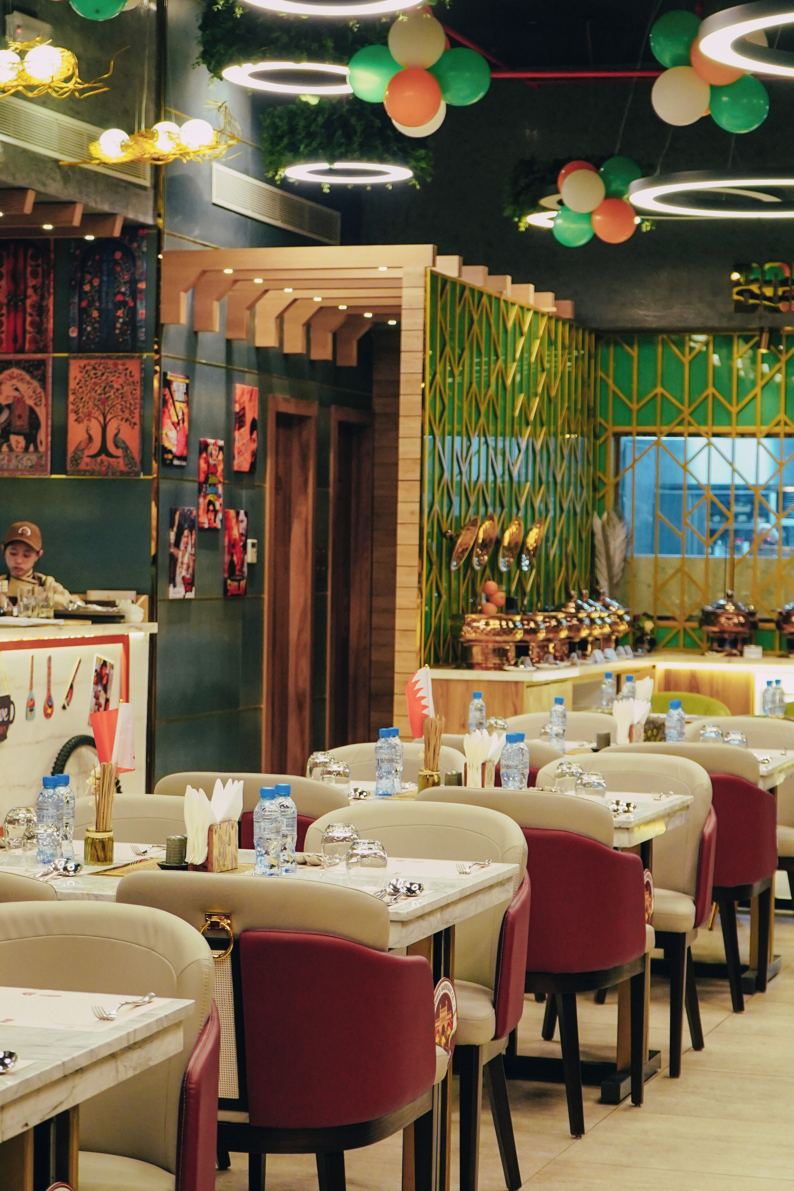 A restaurant interior with tables, chairs, and a counter.
