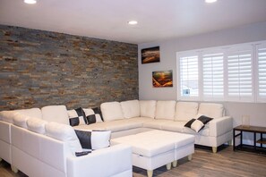 TV, fireplace, books - The Stone Sanctuary @ McCullough Hills Trailhead: 1/2 ACRE, Pool, Grill, Pool Table, 7 TV's, Luxury (Henderson)