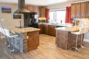 Fridge, microwave, oven, stovetop - The Stone Sanctuary @ McCullough Hills Trailhead: 1/2 ACRE, Pool, Grill, Pool Table, 7 TV's, Luxury (Henderson)