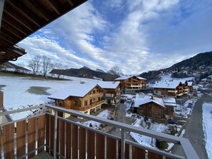 A snow-covered mountain village with wooden buildings and a clear sky.