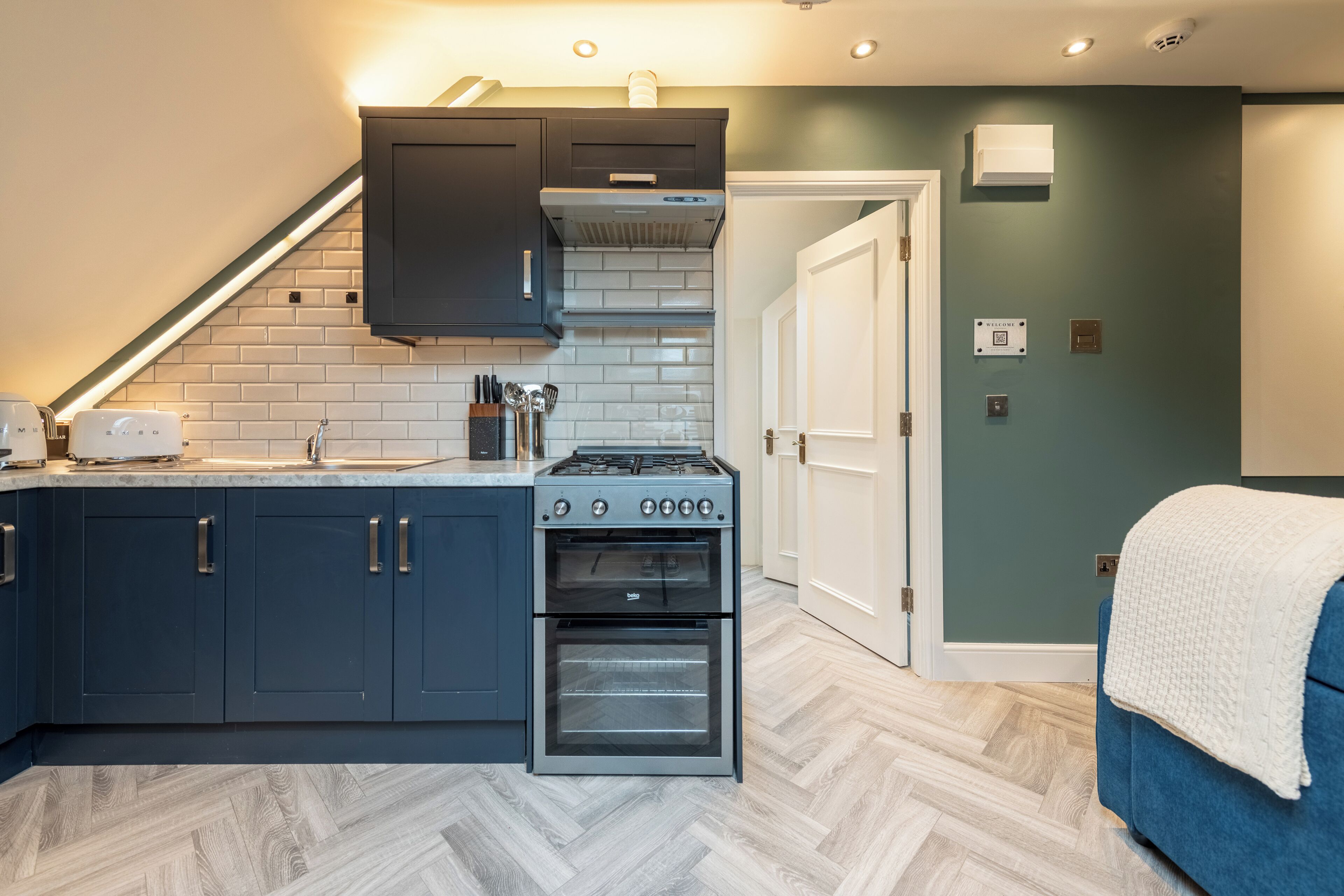 A compact kitchen with dark cabinets, a gas stove, and an oven.