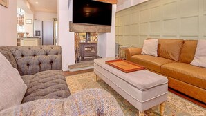A living room with a fireplace, a television, and a sofa.
