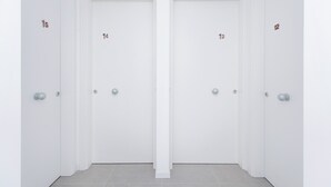 A set of four white doors with numbers 13, 14, 15, and 12 on them. - Appia (Mestre)