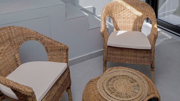 A modern indoor pool area with two wicker chairs and a small round table. - G B Urban Spa by Cretanhouses (Heraklion)