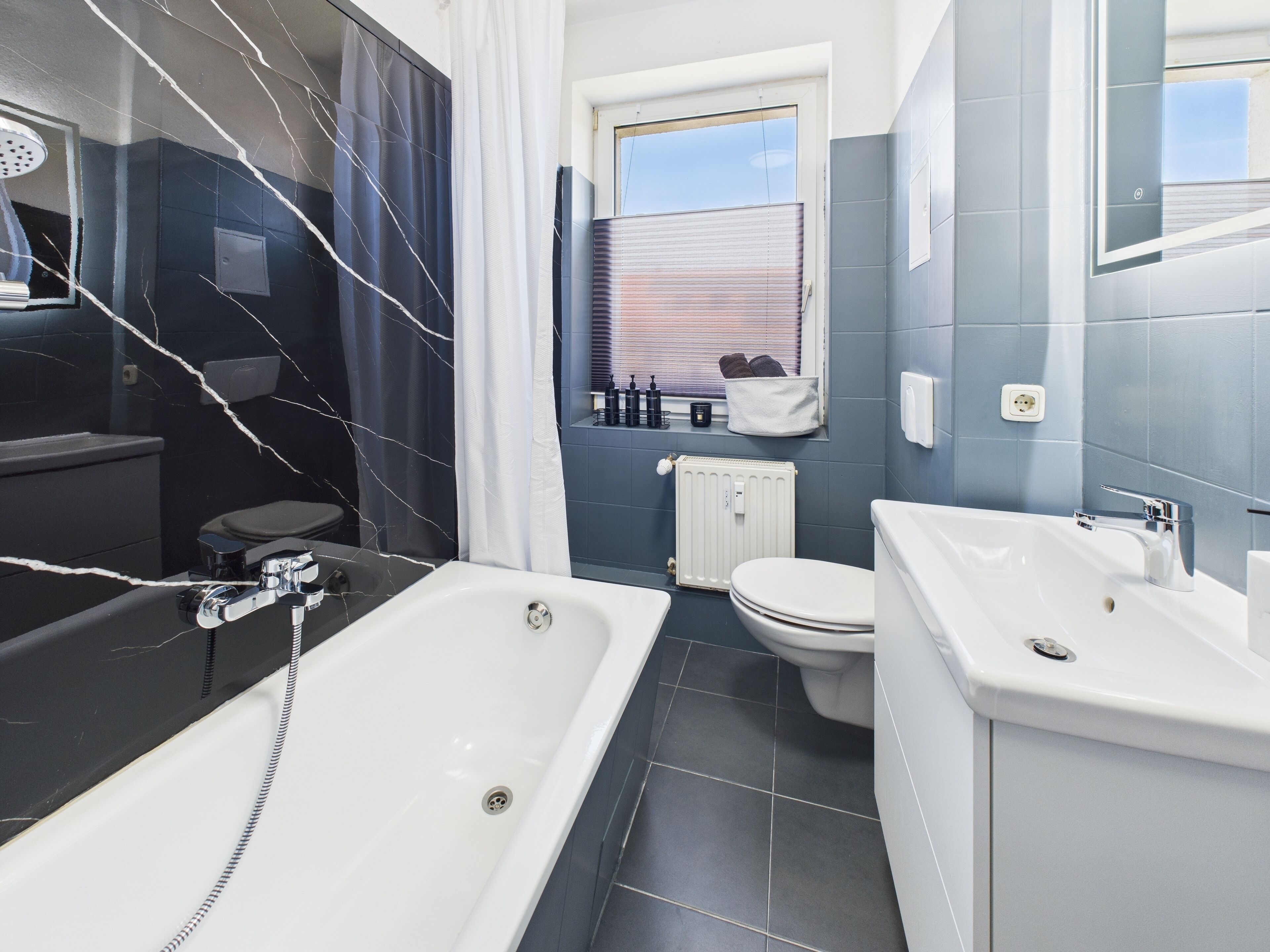 Ein modernes Badezimmer mit einer Badewanne, einer Toilette und einem Waschbecken.