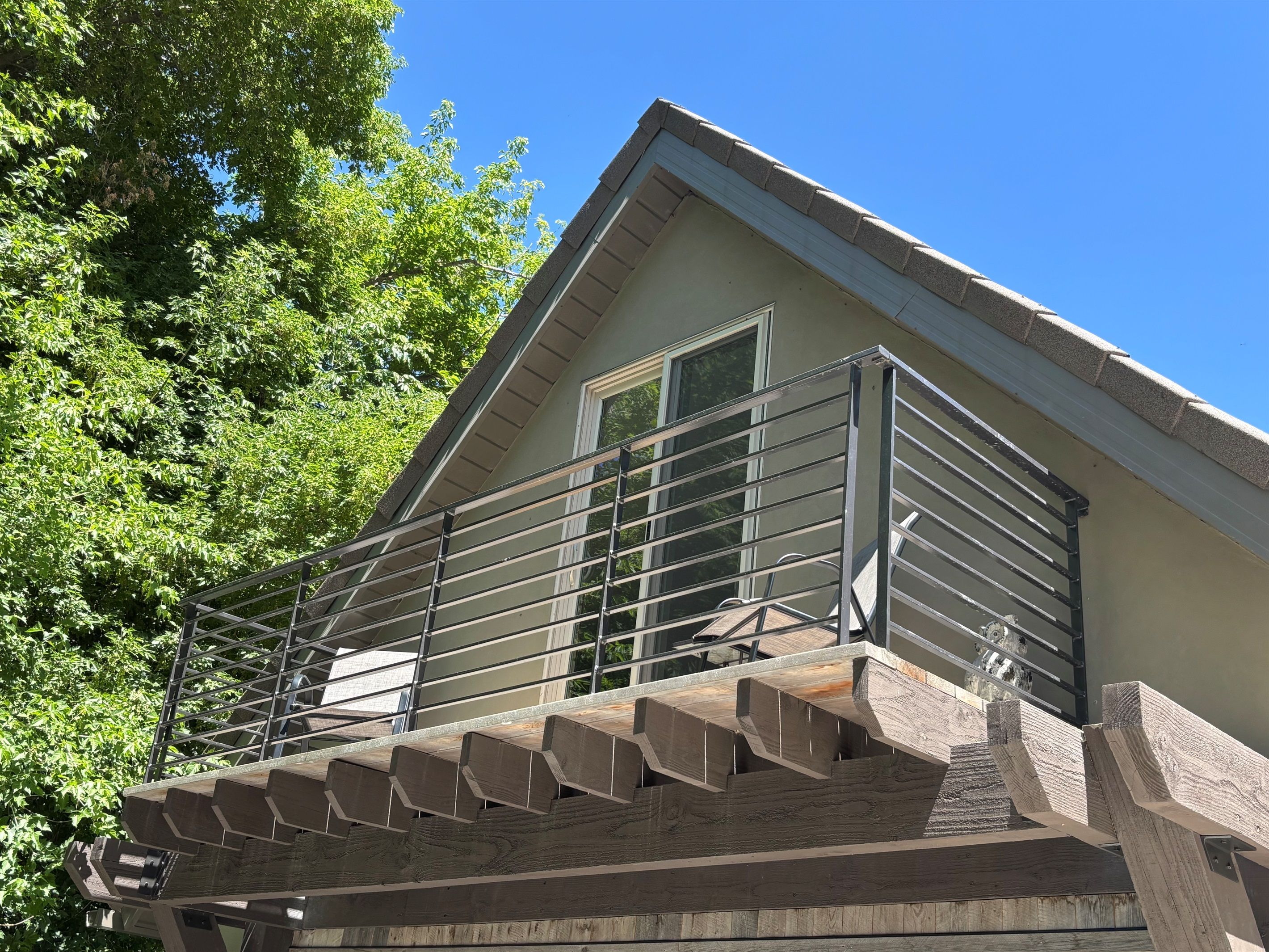 A-frame loft with a balcony and pergola