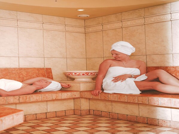 A sauna room with two benches, one occupied by a person and the other by a person lying down. - Penthouse at 1900 Meters Above sea Level (Soelden)
