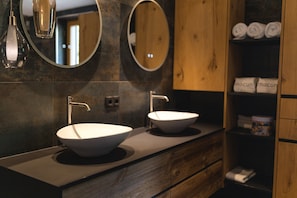 A modern bathroom with two sinks, wooden cabinets, and a mirror. - Penthouse at 1900 Meters Above sea Level (Soelden)