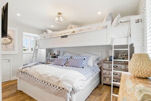 A bunk bed room with a ladder, a desk, and a chair. - Mira Bella - 6630B   “Siesta Key” (Sarasota)
