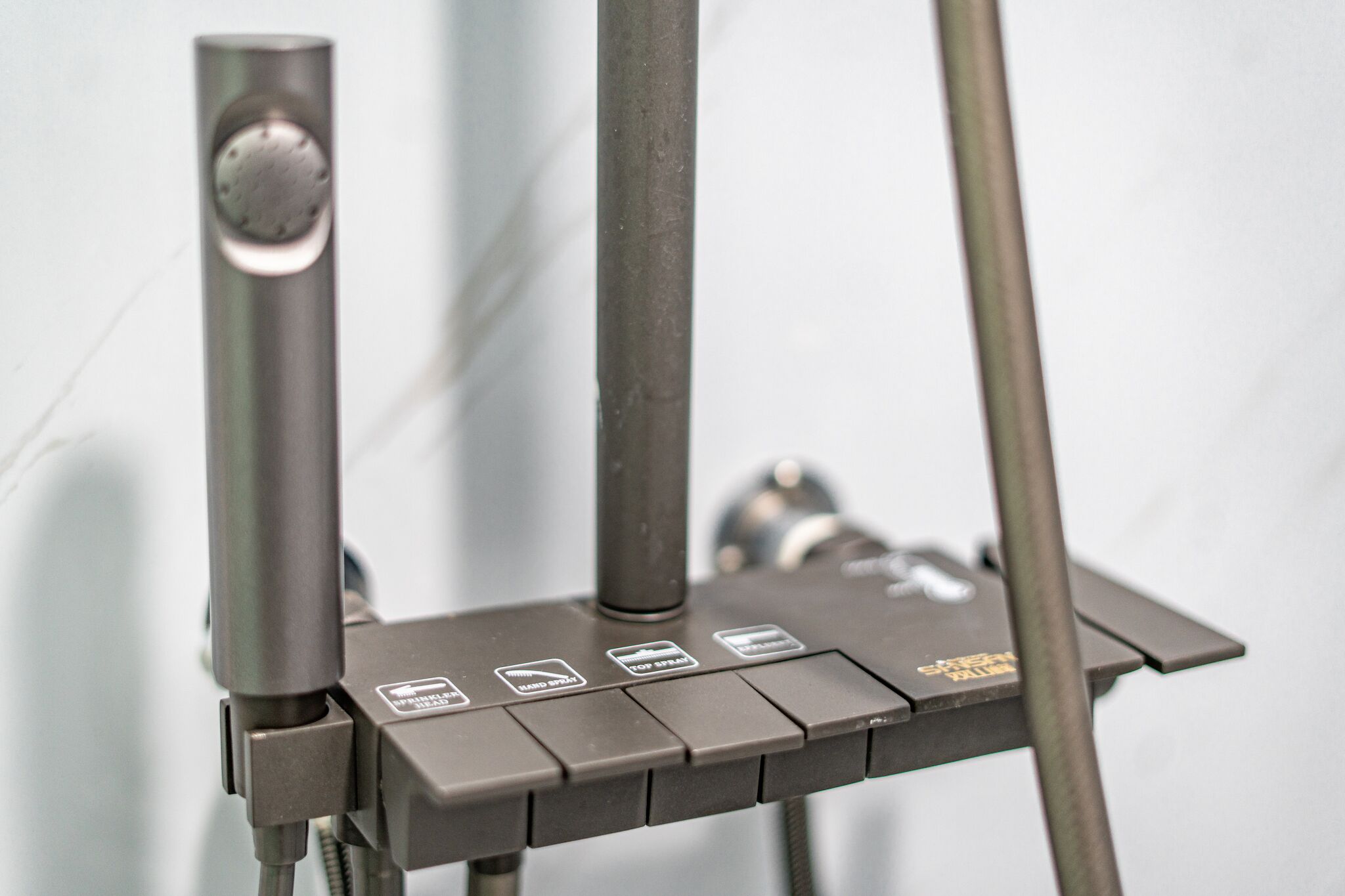 A metallic structure with a control panel featuring several buttons and a knob.