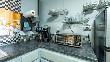 Een koelkast, een oven, een kookplaat, een koffiezetapparaat/waterkoker