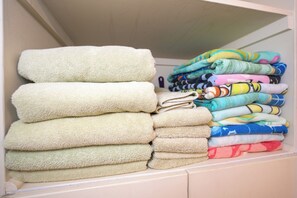 A closet with neatly stacked towels in various colors and patterns. - Koa Lagoon #503 Panoramic Ocean View, 1BD/1BA, Sleeps 4 (Kihei)