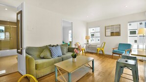 A modern living room with a sofa, coffee table, and chairs. - Chic 1-Bedroom Apt Steps from the Beach in Beautiful Miami Beach (Miami Beach)