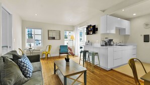A modern apartment with a living room, dining area, and kitchen. - Chic 1-Bedroom Apt Steps from the Beach in Beautiful Miami Beach (Miami Beach)