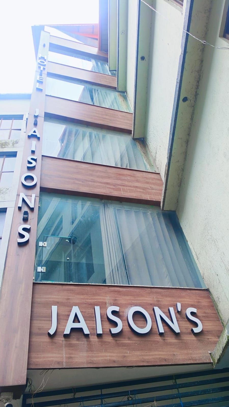 A building with a sign that reads "JAISON'S" on the facade.