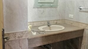 A bathroom with a marble sink, a glass mirror, and a towel rack. - Lovely Appartment in Daroun. Kesserwan (kesrwan)