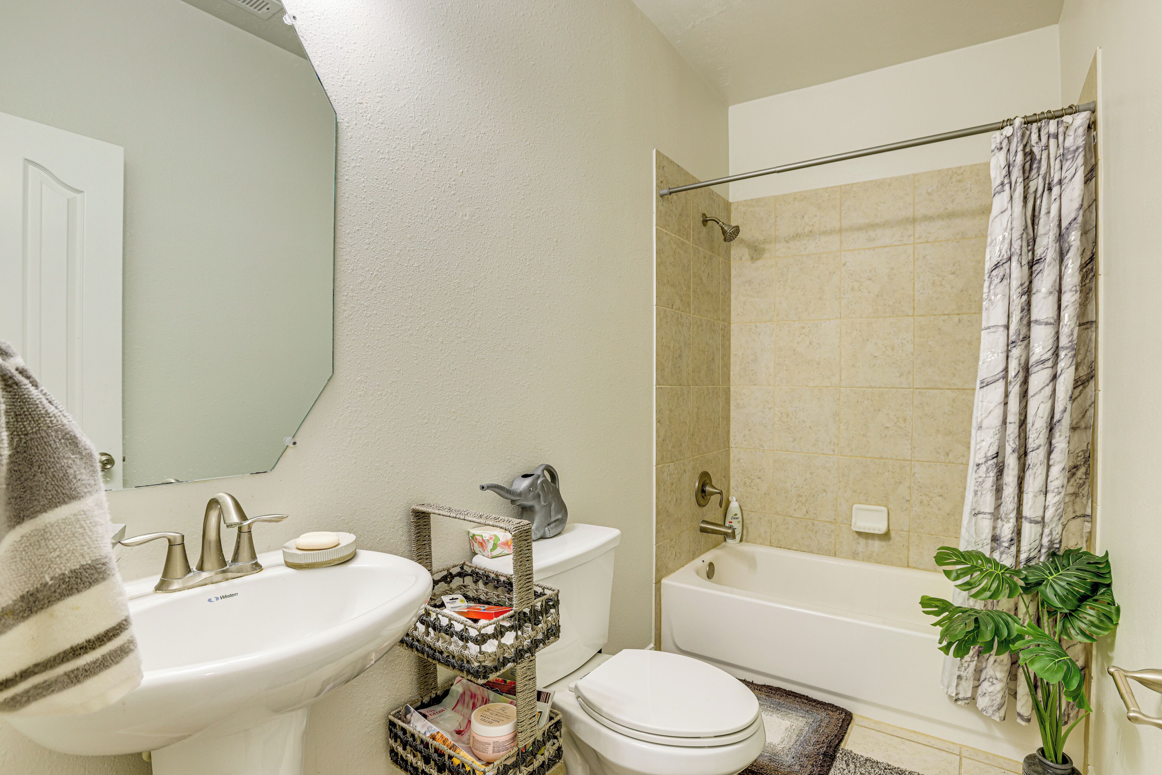 A bathroom with a sink, toilet, and bathtub.