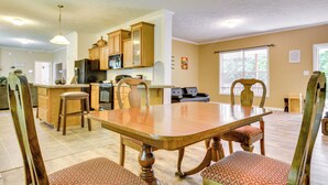 A spacious kitchen with wooden cabinets, a dining table, and chairs. - Peaceful Family Retreat in Winston-salem (Winston-Salem)