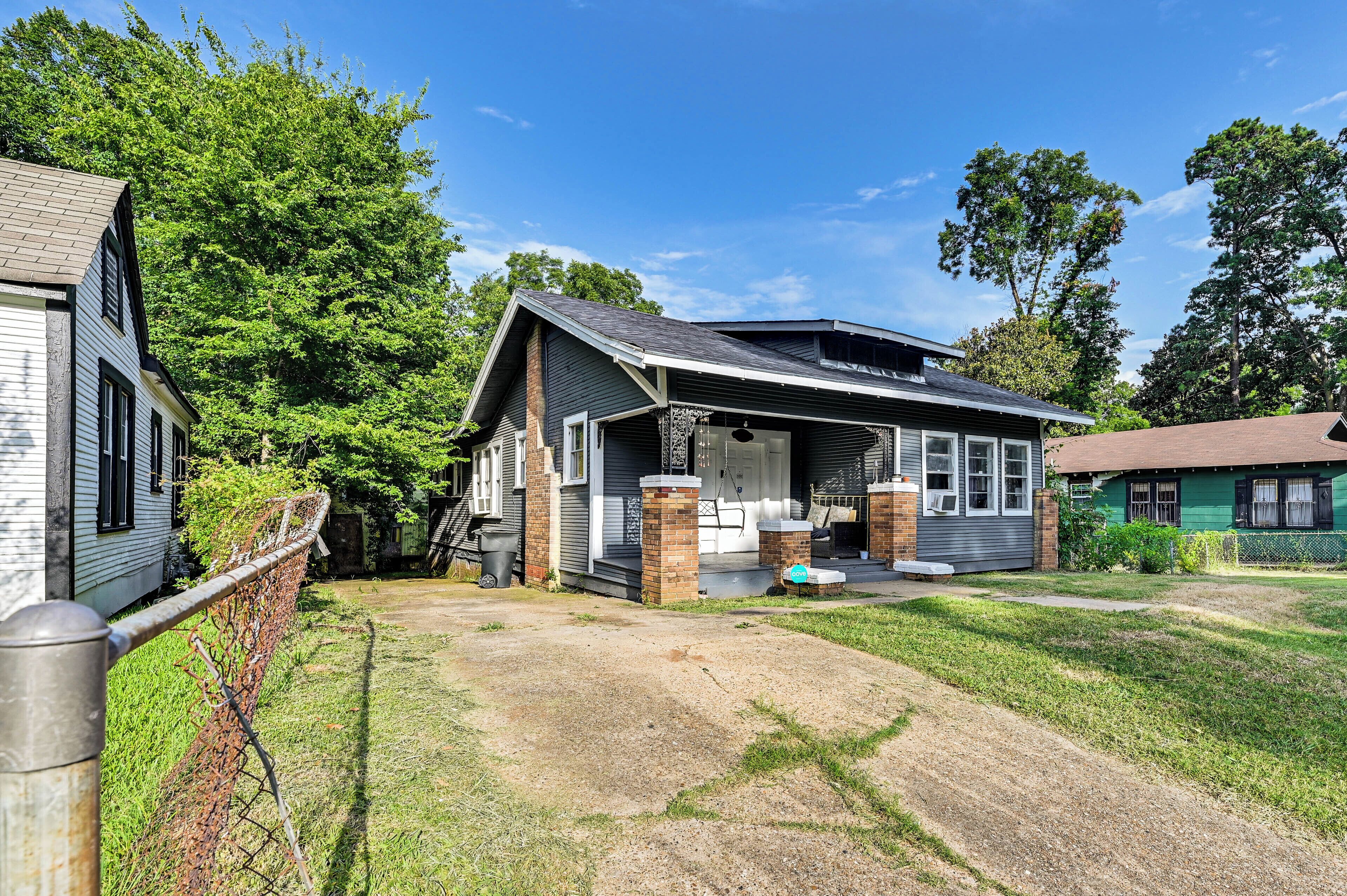 A house with a front porch, a garage, and a yard.