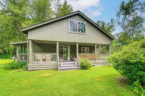 A two-story house with a covered porch, a large window, and a well-maintained lawn. - Games & Outdoor Entertainment: Upstate Family Home (Austerlitz)