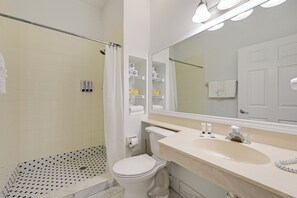 A bathroom with a shower, toilet, and sink. - Dock, Pool & Tennis Courts: Naples Resort Retreat! (Naples)